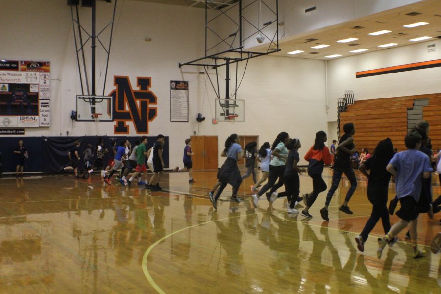 Coach Day’s freshman physical education class suffers through a round of the Pacer to examine their running capabilities. Physical education classes run the Pacer once a week to reach a goal of 80 laps by the end of the semester. 