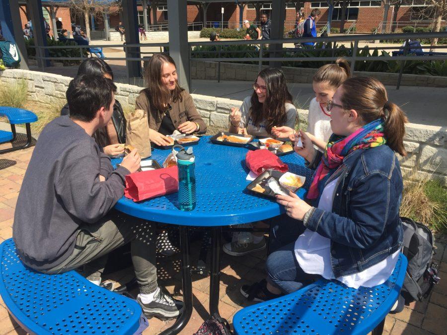 French exchange students reminisce over their past six days in America during lunch, and converse in their native language. “We visited the CNN center, everything is expensive in America, so we are ready to go back,” said foreign exchange student Marion Morin.