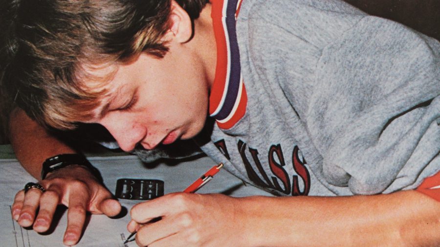A 1988 NC student diligently concentrates on his classwork while on his right hand he sports his personalized class ring.