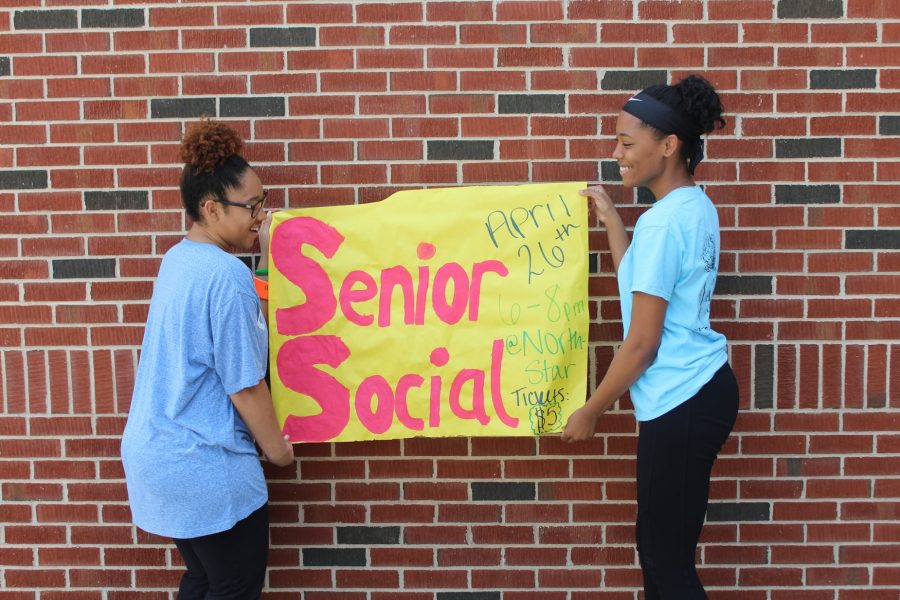 The senior organizers of the senior social, Briana Anderson and Keala English, pose for a picture with one of many posters they made to advertise the senior social which takes place April 26. 
