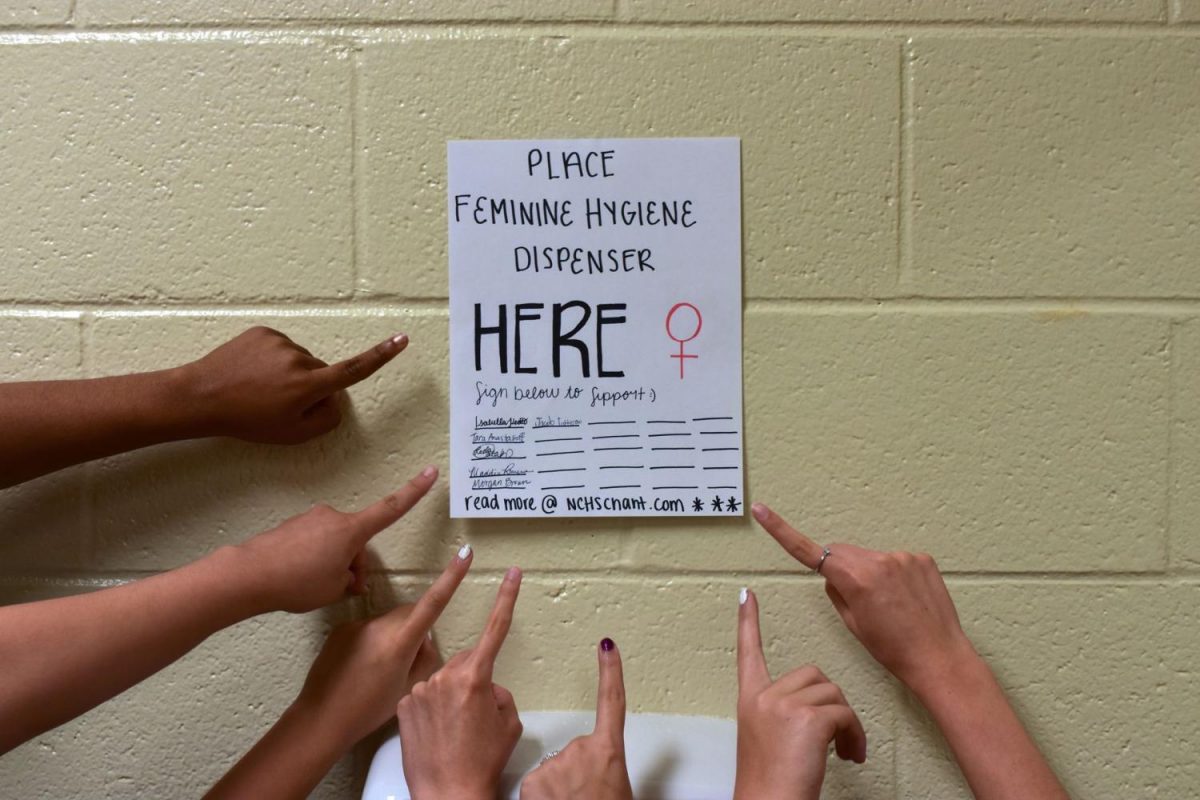 Placed in the girl bathrooms of NC, feminine hygiene dispenser posters give students the
ability to voice their own opinion. As girls go to the bathroom, they can pull out their pens and
pencils to show support. The issue of the lack of accessibility of menstrual products becomes
more evident as women start to speak up at NC.