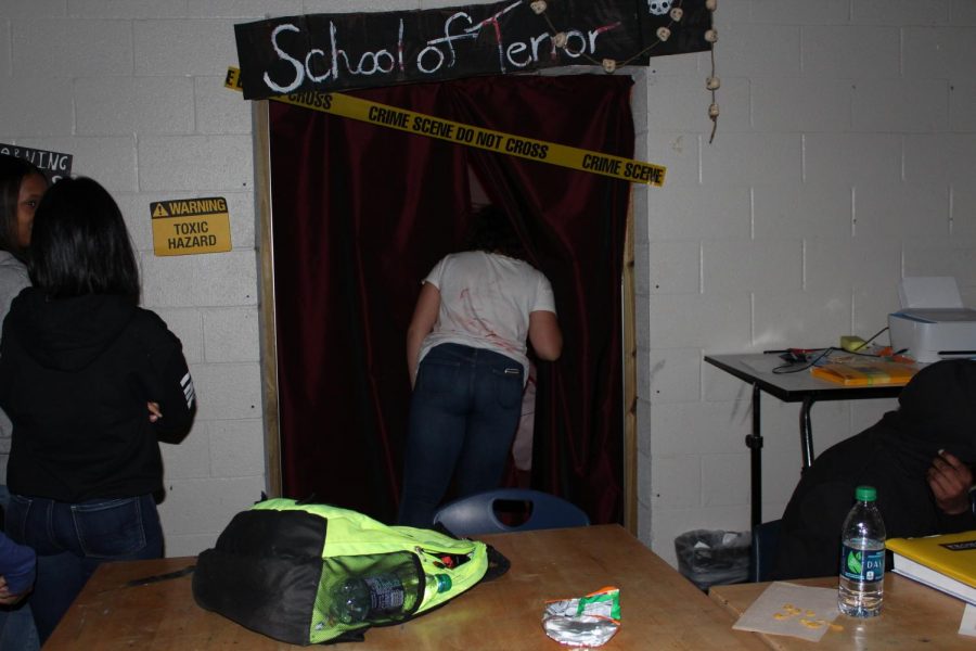 NC students in art club created a haunted house in Mrs. Dowling’s Room for Halloween. “It took us about a good week to do it. Students used it as an extension of their regular activities in the art room; they brought in the necessary supplies and did face painting and all different types of makeup in addition to decorating in there,” Mrs. Dowling said. Curious students who congregated outside of the haunted house,  titled “School of Terror,” were advised to keep their eyes open and go all the way through, no matter what. 