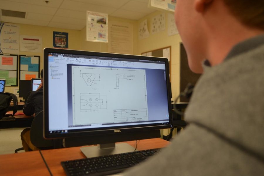 Student Aiden Minard looks at different models to prepare for SkillsUSA. The organization seeks to prepare young minds for the workplace by instilling skills that can be used immediately out of school.  The NC SkillsUSA chapter now spends their time putting the final touches on their products, such as sports highlights and music videos. 