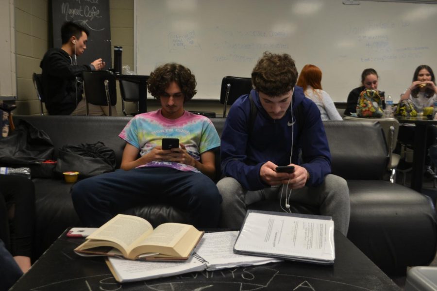 Magnet seniors Cameron Buxton and Marco Mancuso ignore their homework and busy themselves with looking at their phones. “Teachers are understanding that it’s senior year and kids are starting to unwind and do less school work,” Mancuso said. 