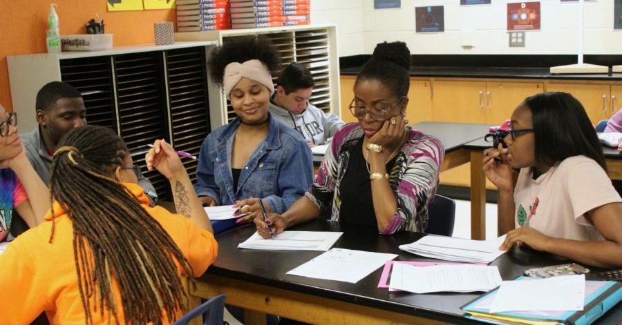 Physics teacher Elizabeth Walker conducting a study session during lunch with her students. As the only black female teacher in the science department, Walker aims to inspire young girls to pursue careers in the STEM field. She attributes the lack of diversity in education to the extensive steps it takes to become a teacher. “The issue of finding people to educate is not as difficult as the red tape an educator must go through to only become a teacher… The problem rests with the narrative of what public schools are… and like I said there’s a lot of bureaucracy involved in education now that really leaves a bad taste in the mouths of anyone aspiring to make this a lifelong career,” Walker said.
