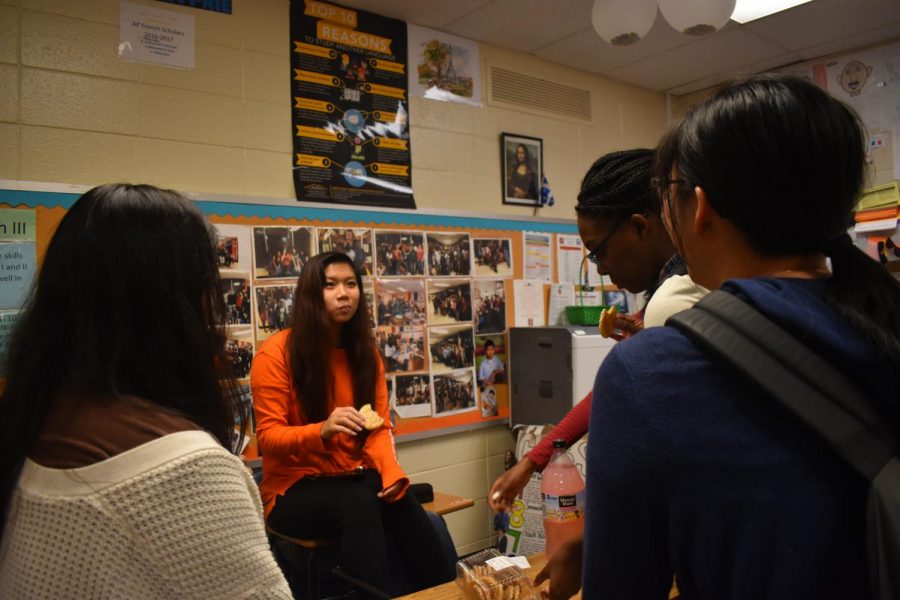 African Caribbean club members experience and admire the beat of the African and Caribbean music. The students gather around excitedly, chat with friends while enjoying refreshments, and prepare for the meeting to begin.