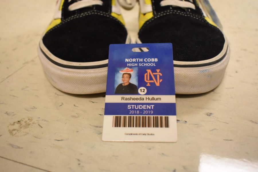 Senior Rasheeda Hullum placed a single red Vans shoe on her head for her senior ID shot. Vans represent Hullum’s favorite type of shoe and red remains her favorite color. “It was kind of last minute, I wanted to do something weird but not too crazy that still represented me,” Hullum said.