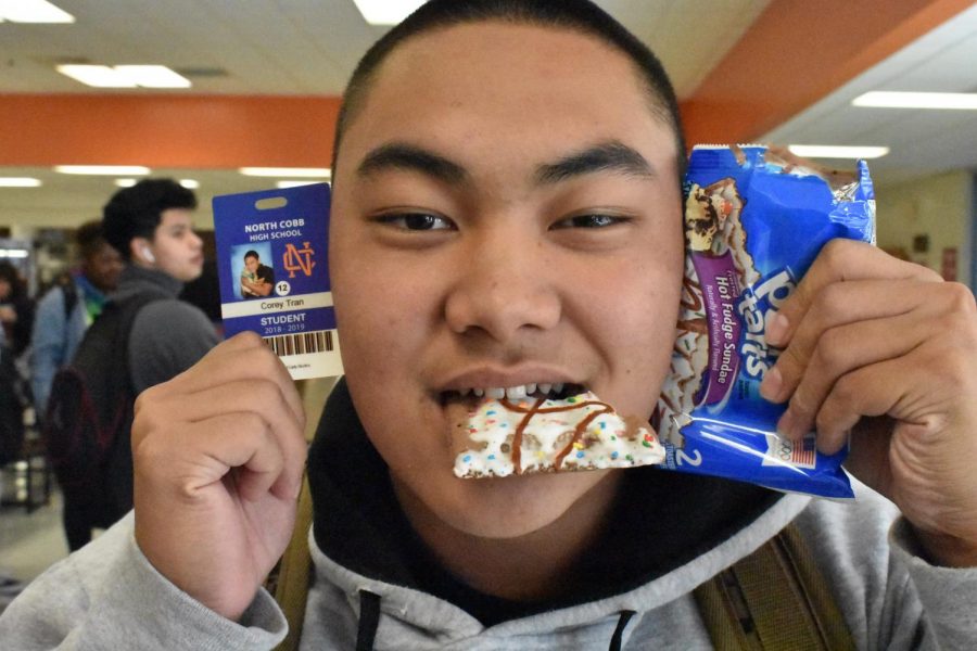Senior Corey Tran forgot about picture day, but could not miss out on his signature silly senior picture. Pulling out his wallet to substitute forgotten props, Tran saved his senior ID picture by splurging at the vending machine. Tran loaded up on crisps and crunchies, coddled them close, and smiled big for his picture. “We ended up spending like $20 on the vending machine snacks,” Tran said.