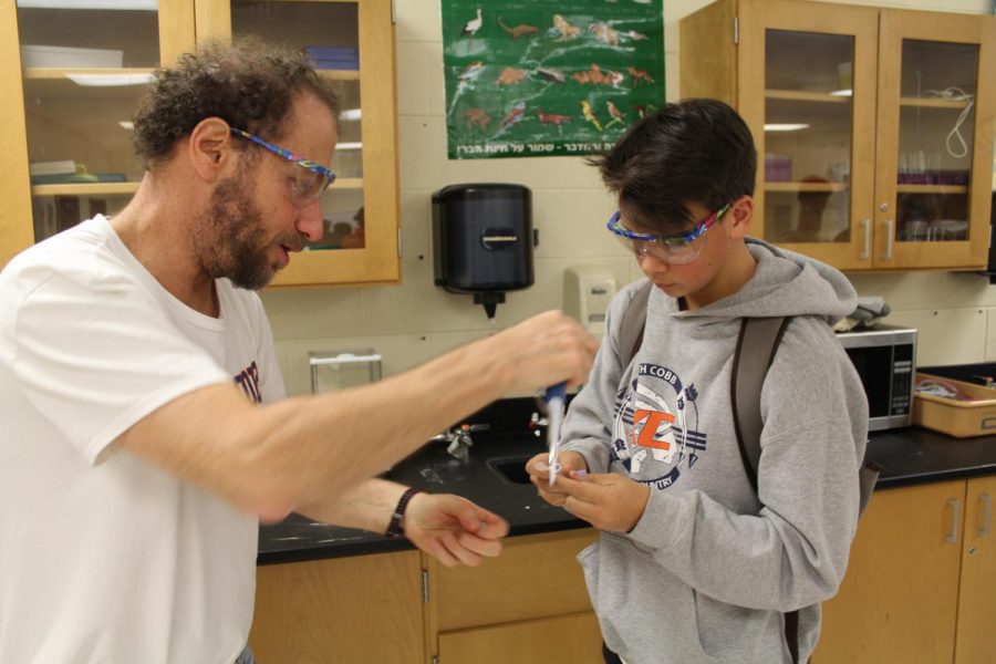 Doctor Gorlin aids a student in the analysis of DNA near the end of his second period biology class. Admired by many of his students (current and past) for his willingness and joy at helping his students in any way he can, Gorlin clearly puts as much time into his work as he can, admitting that to “I was pretty much here every morning from 6:30”, so as to finish as much work as possible.