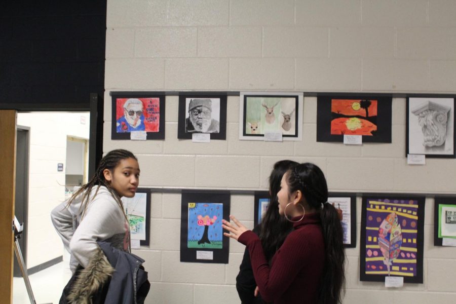 Visiting students from Awtrey Middle School admire the work from Mrs. Dowling’s & Mrs. Brewer’s art class. Yesterday marked the beginning of the NC Visual Art class’ annual Art Show; during this exhibition, up and coming art students from all of the NC feeder schools (Barber, Paulding, etc.) come to analyze the art of Brewer’s and Dowling’s class, so as to gain a better understanding of techniques used.