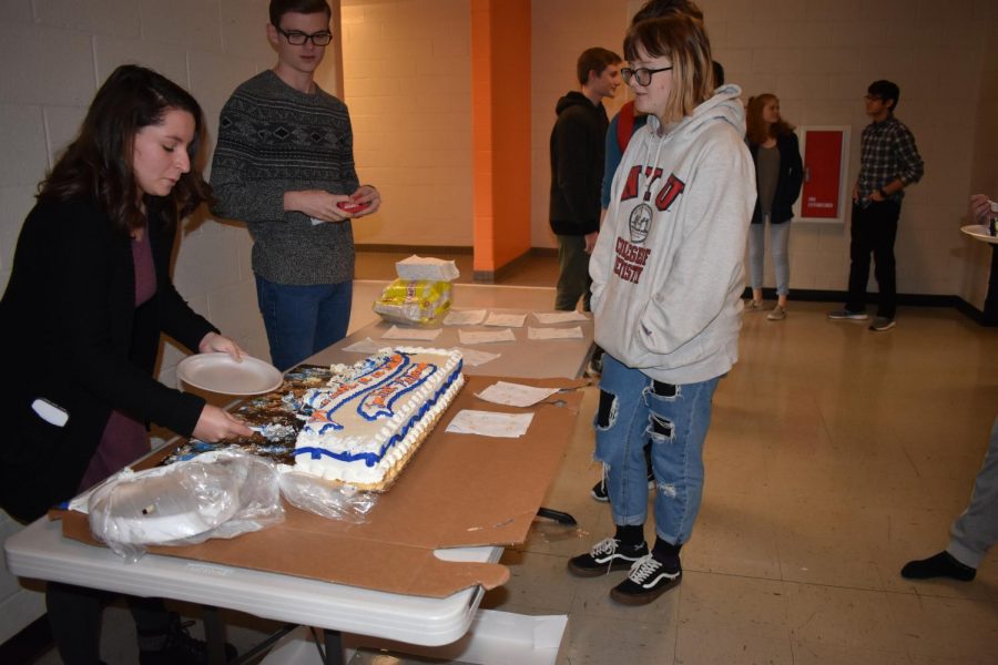 Kennesaw State student teacher, Brianna Curtis and Senior Andrew Riner distributed cake to students to celebrate the band’s performance at the University of Georgia. Students enjoy the celebratory cake from their success at their trip on Friday, January 18. “We performed at UGA because we submitted a recording and they accepted us. It was fun because we got to perform in front of all these students from around Georgia,” senior Sarah Goddard said.  