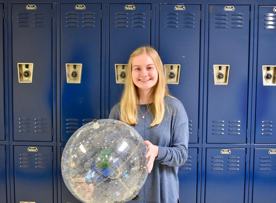 NC senior Rebekah Geil poses with a celestial sphere. Since a freshman-year trip to the U.S. Space and Rocket Center in Huntsville, Alabama, first piqued her interest, Geil has developed a passion for the world of space exploration. She now hopes to parlay her interest into a career as an aerospace engineer.