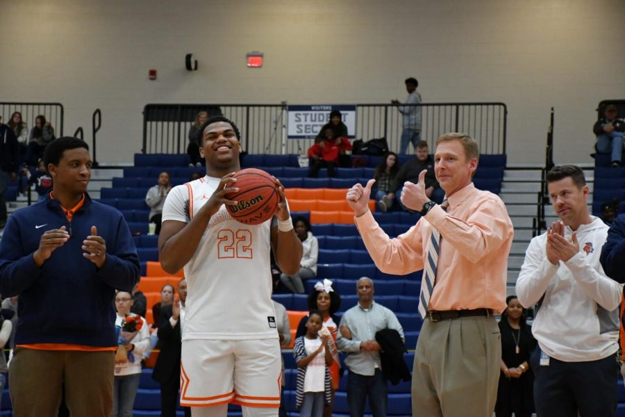 Varsity Boys Basketball coach Terry Gorsuch accompanies senior player Kevin Hester during senior night, saying a farewell to a significant part of his 2018-2019 season coaching basketball. “Each Senior group is special—these four seniors have been awesome and I will truly miss them. Shota Suzuki, Kevin Hester, Josh Moten, and Tyrese Crawford have done so much for the program the last four years,” Gorsuch said. 