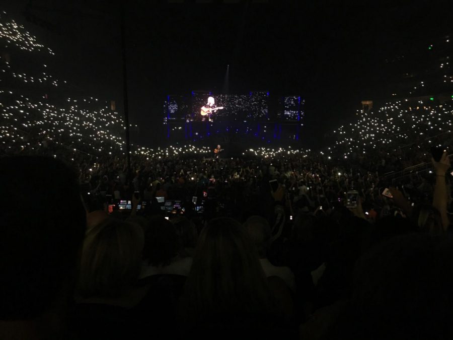 Brian May performing Love of My life at the State Farm Arena. The crowd singing along, carrying the song while swaying their flashlights.