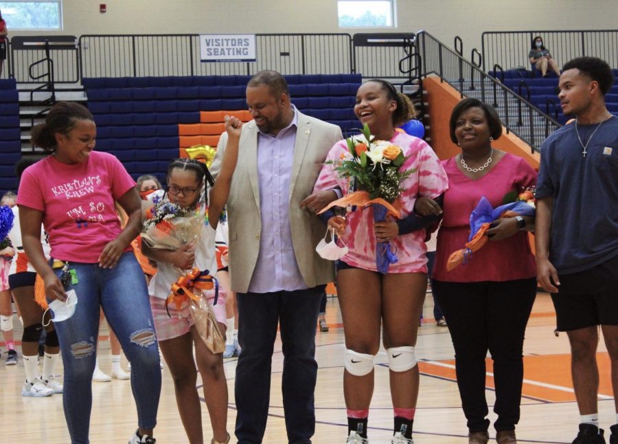 Escorted by her parents and three siblings, Senior setter Kayla Johnson laughs with her family during an event she has eagerly awaited since joining the varsity team her freshman year. Over the course of her NC volleyball career, she won two AAU club tournaments and received the title of GACA Junior All Star when she recorded 101 aces throughout the duration of her junior season. After graduation, Johnson plans to pursue cosmetology while majoring in business.
