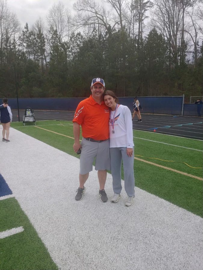Pictured above, NC senior Bella Van poses with her coach, Mike Turchman, for a photo. Van pole vaults for the track and field team, along with cheering for the varsity cheer squad. This season, Van became the second-highest vaulter to ever jump at NC and made third place at the county meet. Once graduating, she will attend the University of Mississippi to study Kinesiology. 
