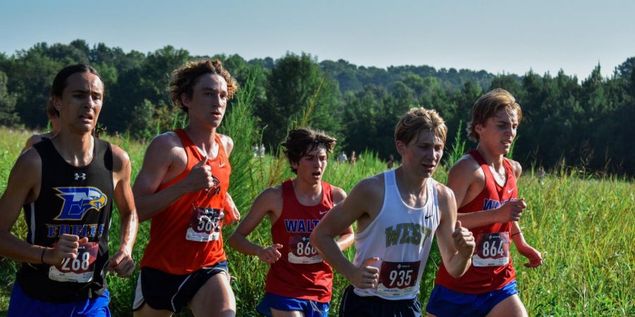 Magnet senior Bentley Huff runs his race, competing against other runners in the fastest boys time bracket. As a fourth year runner, Huff witnessed the team’s evolution over the years. “I definitely think the culture is a little different, because my first two seasons we were in a different region and we were always in state contention. Last season was a wake up call, because we got put in a much harder region, so last season was kind of rough on all of us and we kind of all went into a bad mentality, but I think this season is definitely better and we at least have a chance,” Huff said.