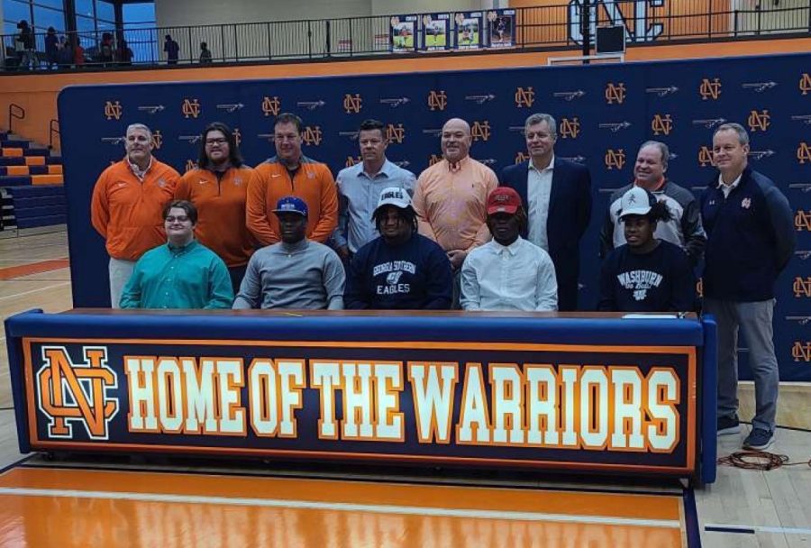 Isaiah Blake, Joshua Bagley, Latrell Bullard, Zach White, and Aidian Williams commit to their school of choice to pursue their football career. Blake signs to Shorter University,Bagley signs to Point University, Bullard signs to Georgia Southern University, White signs to Georgia University, and Williams signed to Washburn University. Above the players stand North Cobb coaches and administration.
	“I told my mom I wouldn’t break my promise; now look at me,” Blake said.