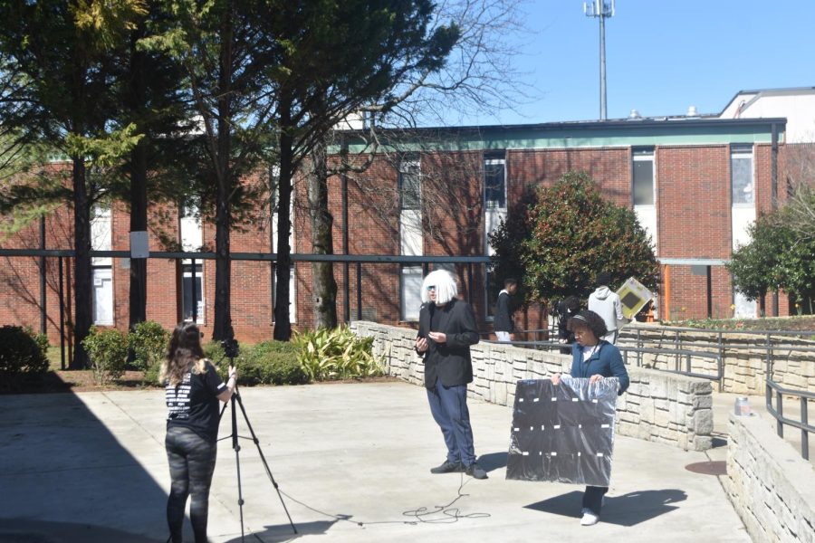 	Audio-Video Technology and Film third period students did a lighting project in the courtyard today. Students in each group built their own lighting reflector so they can use it to light up their subject in their recorded videos. In contrast to the recent cold days, the sun shining bright today allowed them to produce the best results possible. “Two different sets of lights are going on, some students are in a studio recording an interview using three point lights, and the others are doing the project outside,” teacher Daniel Knode said.
