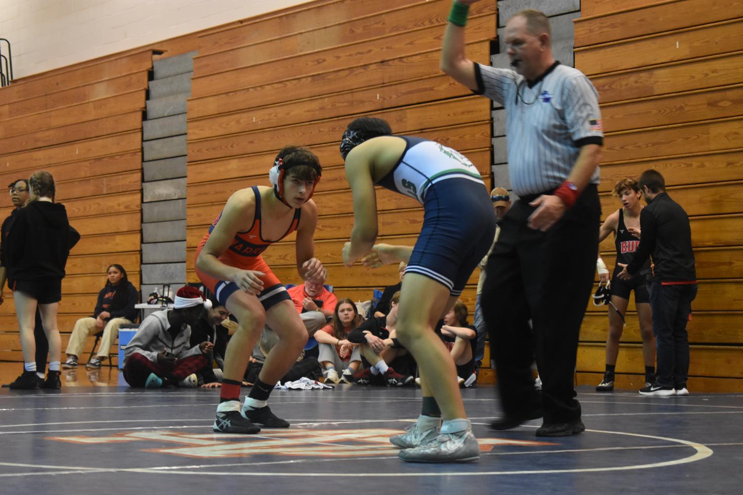 NC freshman Jayden Bryant prepares to compete against his opponent, Brodee Tull from Harrison High School. Bryant proceeded to win the match by pinning his opponent on the mat. He later placed third overall in the 132 lbs weight class for the tournament.