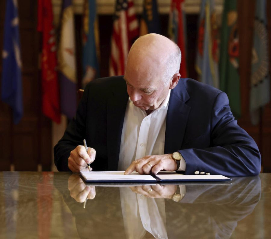 In this photo provided by the Montana Governors Office, Republican Gov. Greg Gianforte signs a law banning TikTok in the state, Wednesday, May 17, 2023, in Helena, Mont. That law made Montana became the first state in the U.S. to completely ban TikTok. (Garrett Turner/Montana Governors Office via AP)