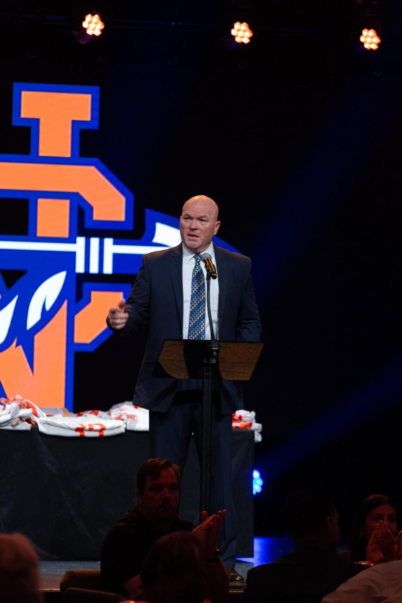 Head Football Coach Shane Queen delivers a speech at the 2023 football banquet.