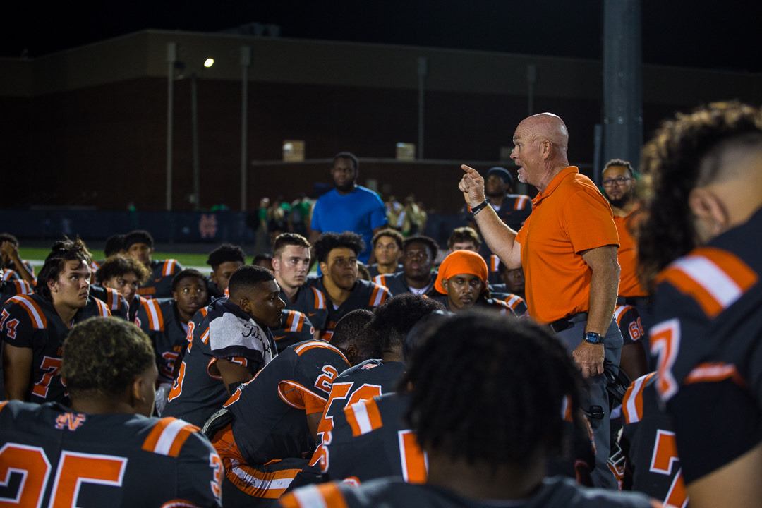NC Head Football Coach Shane Queen delivers a pep talk to his team during halftime.