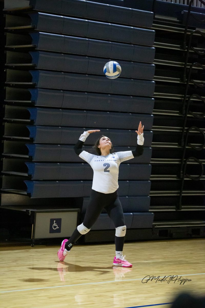 Freshman Megan La Borde (2) sets the ball during a 575 Club Volleyball match.