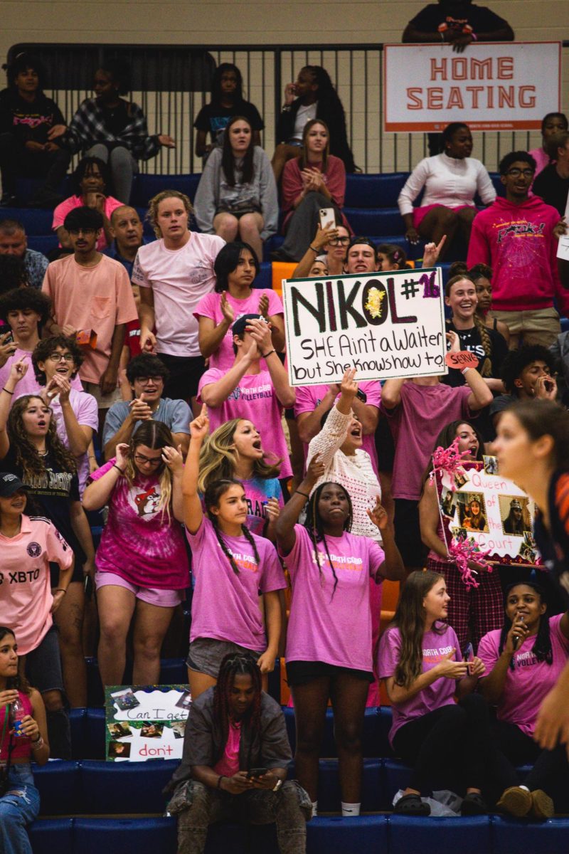 Students cheer on the NC Varsity Lady Warriors Volleyball team during their state match.