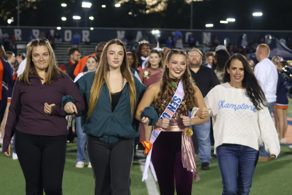 Color Guard senior Serenity Norris showed off her pearly white teeth while she listened to the announcer proudly state her name.
