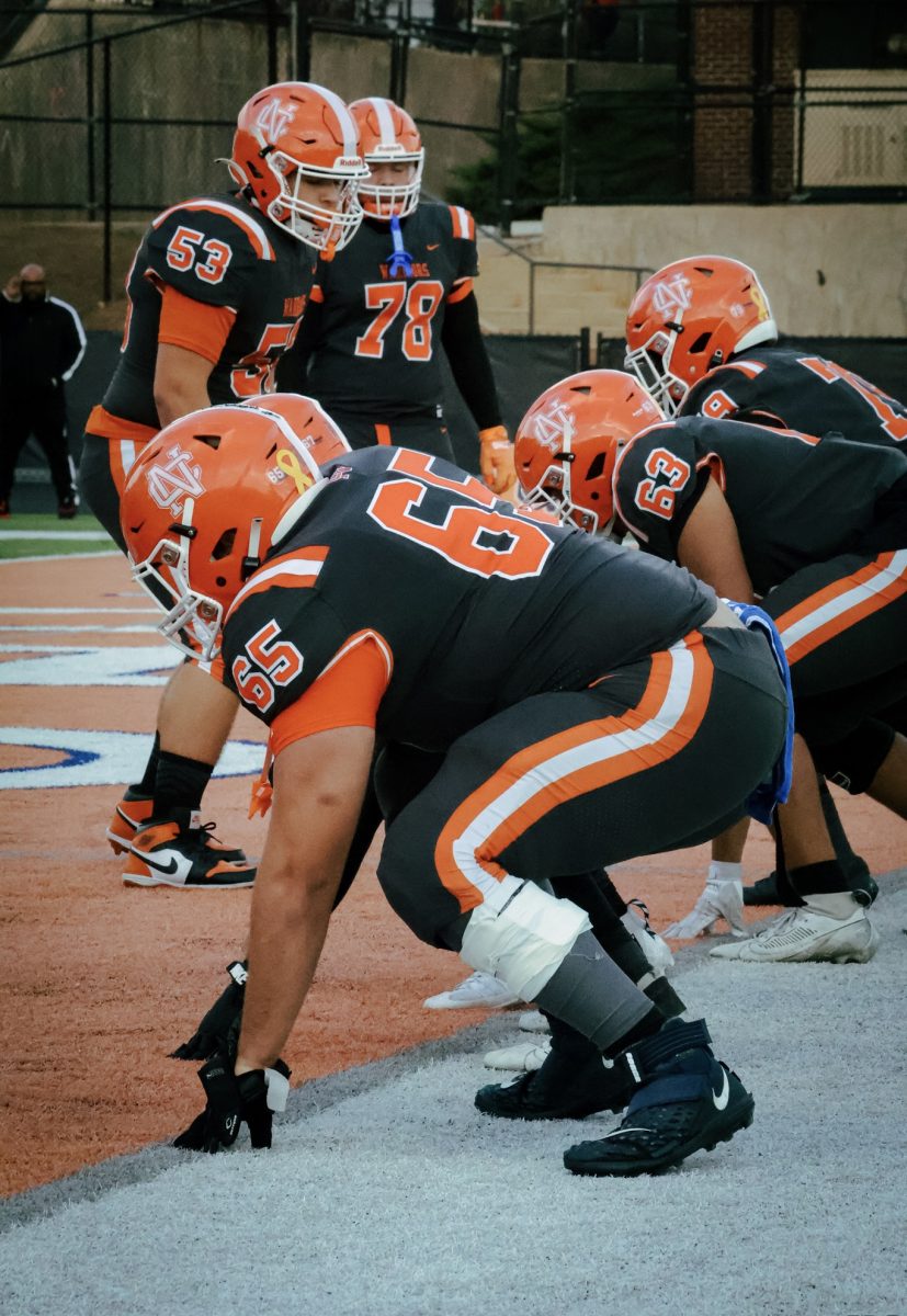 Junior tackle Madden Fredenburg warms up with his teammates.
