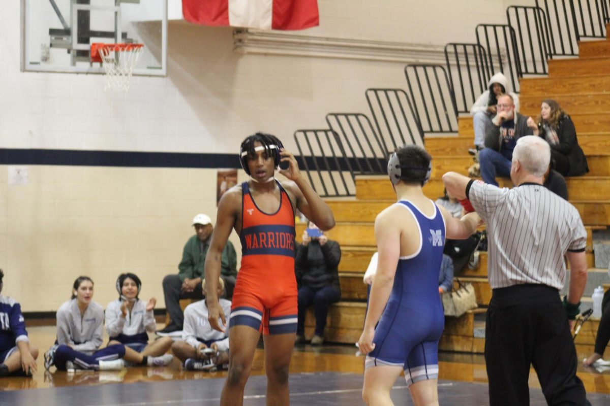 JV sophomore Will Conley (150) looks at the audience for encouragement.
